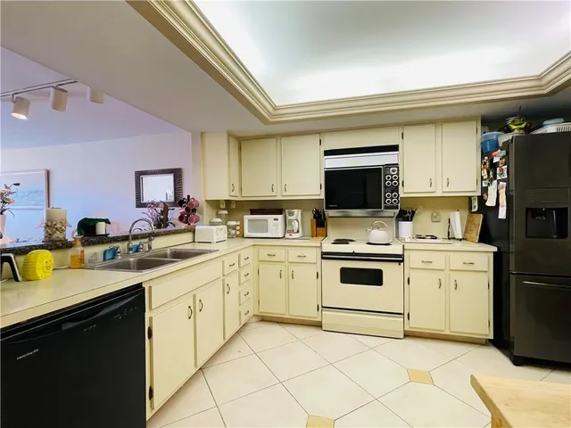 a kitchen with a sink a stove and cabinets