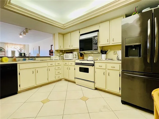 a kitchen with a stove sink and refrigerator