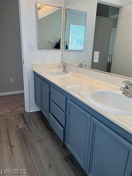 6532 Moon Roses Court Las Vegas, NV 89108 - Photo 7 of 8 Bathroom featuring double vanity, a sink, and wood finished floors