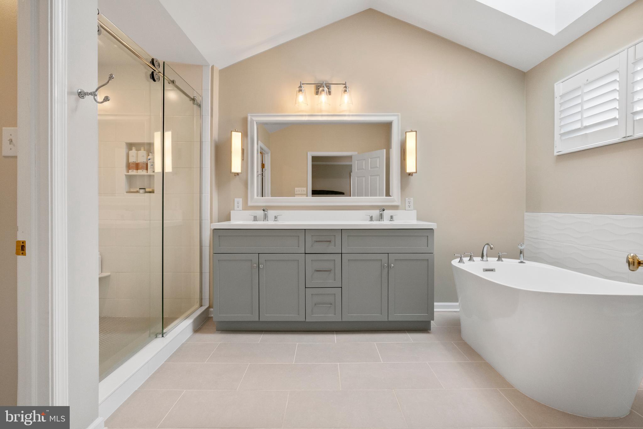 285 Cherry Lane Kennett Square, PA 19348 - Photo 31 of 38 a spacious bathroom with a bathtub sink mirror and