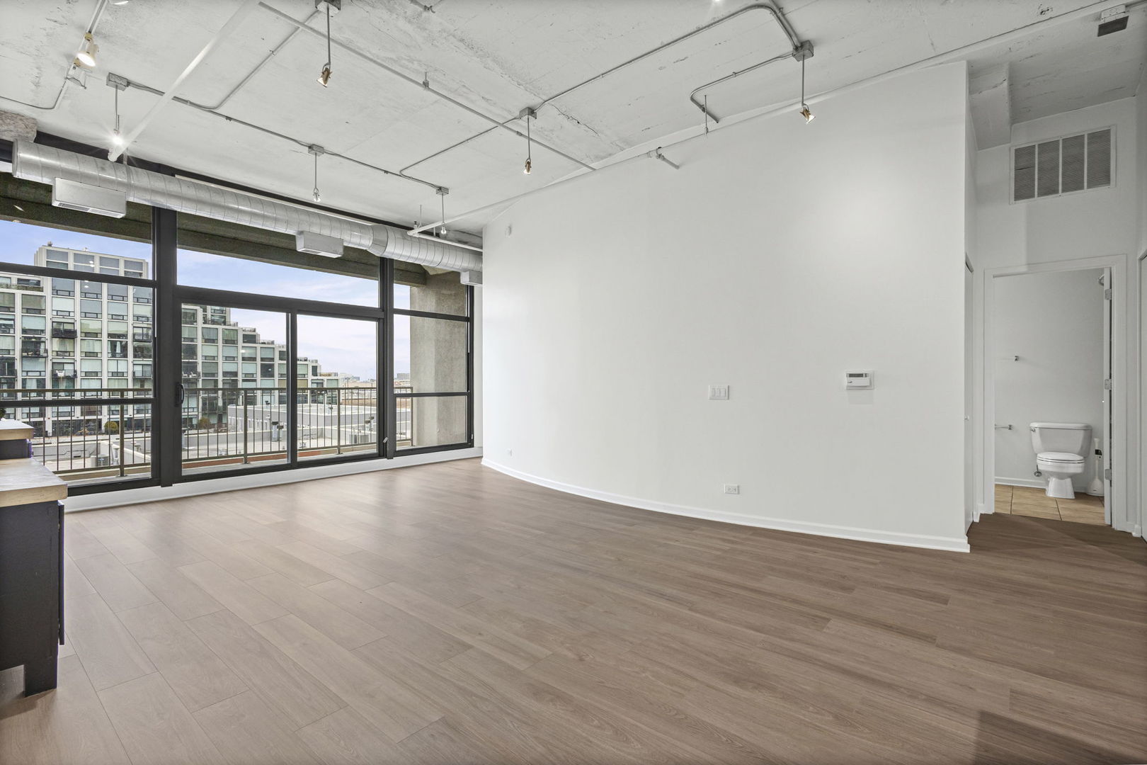 1530 South State Street, Unit 431 Chicago, IL 60605 - Photo 2 of 15 a view of room with wooden floor