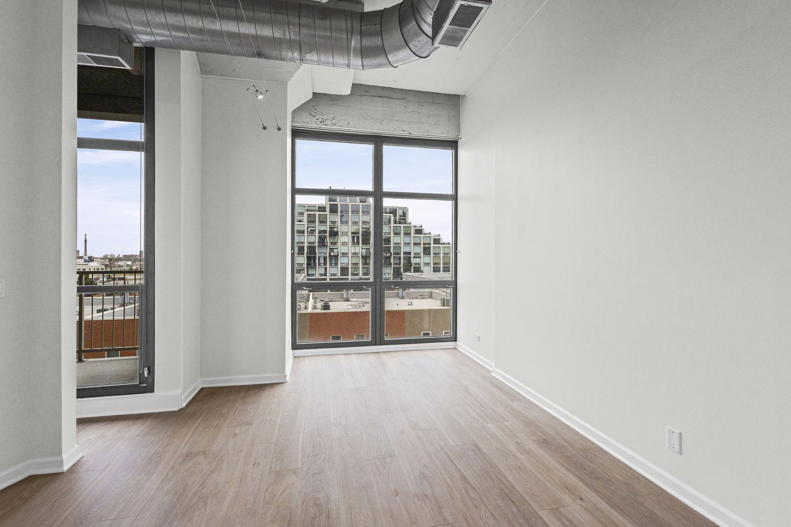 1530 South State Street, Unit 431 Chicago, IL 60605 - Photo 7 of 15 an empty room with wooden floor and windows