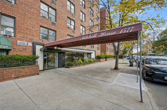 a view of a building with car parked