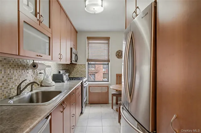 a kitchen with stainless steel appliances granite countertop a refrigerator and a sink