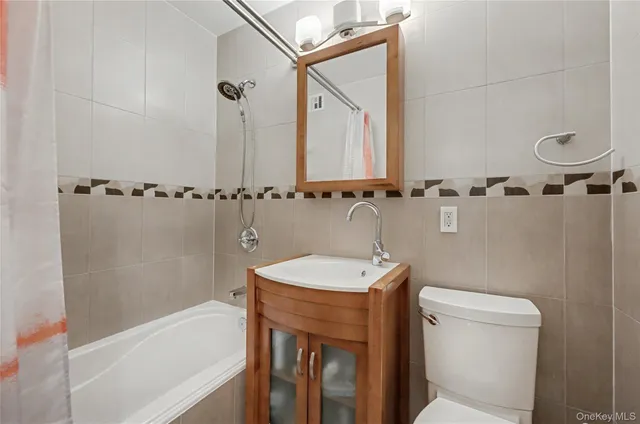 a bathroom with a sink a toilet a mirror and shower