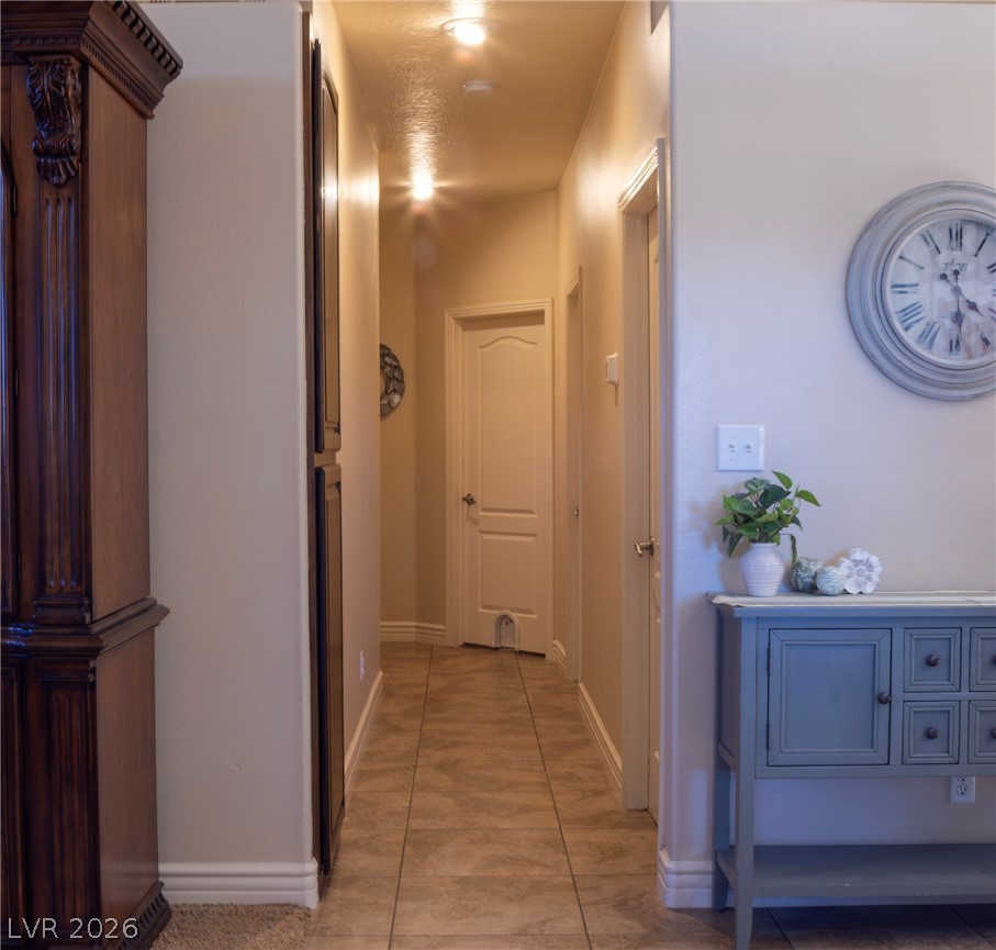 2775 Taylor Street Logandale, NV 89021 - Photo 20 of 41 This inviting hallway features tile flooring and well-maintained walls, guiding you through the home's thoughtful layout.