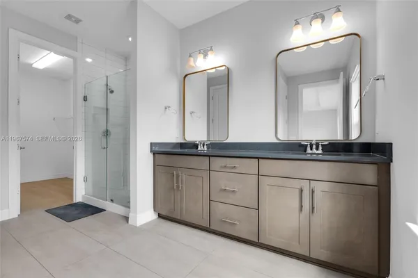 a bathroom with a double vanity sink and a mirror