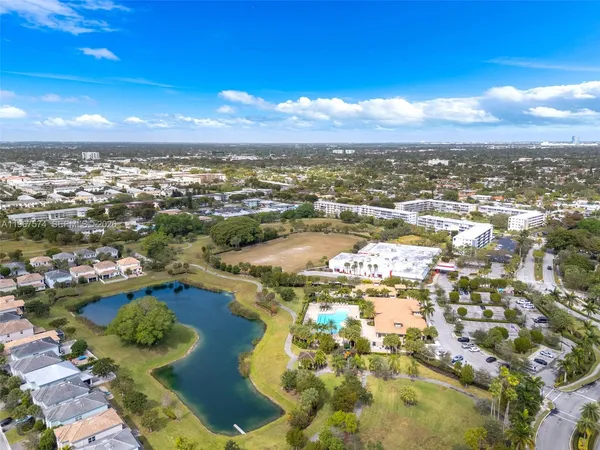 a view of a city with lots of residential buildings ocean and mountain view in back