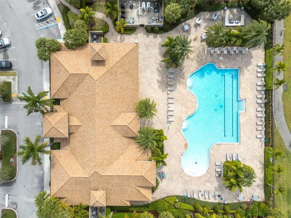 an aerial view of residential houses with outdoor space and ocean view