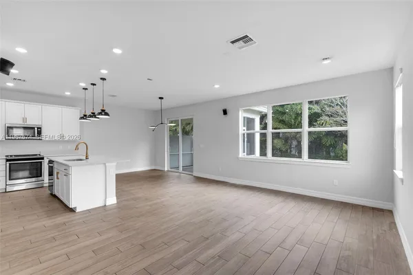 a view of kitchen with sink and wooden floor