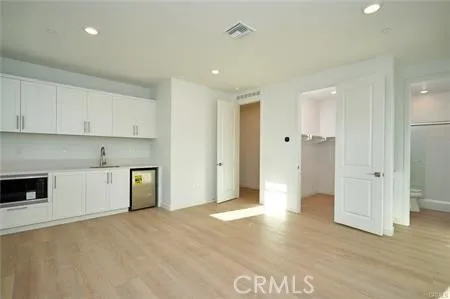 a view of a kitchen with a sink and a stove top oven