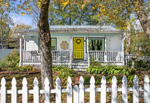 a front view of a house with a garden