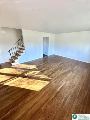 a view of a room with wooden floor