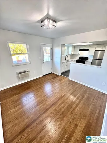 a kitchen with granite countertop a sink stainless steel appliances and counter space