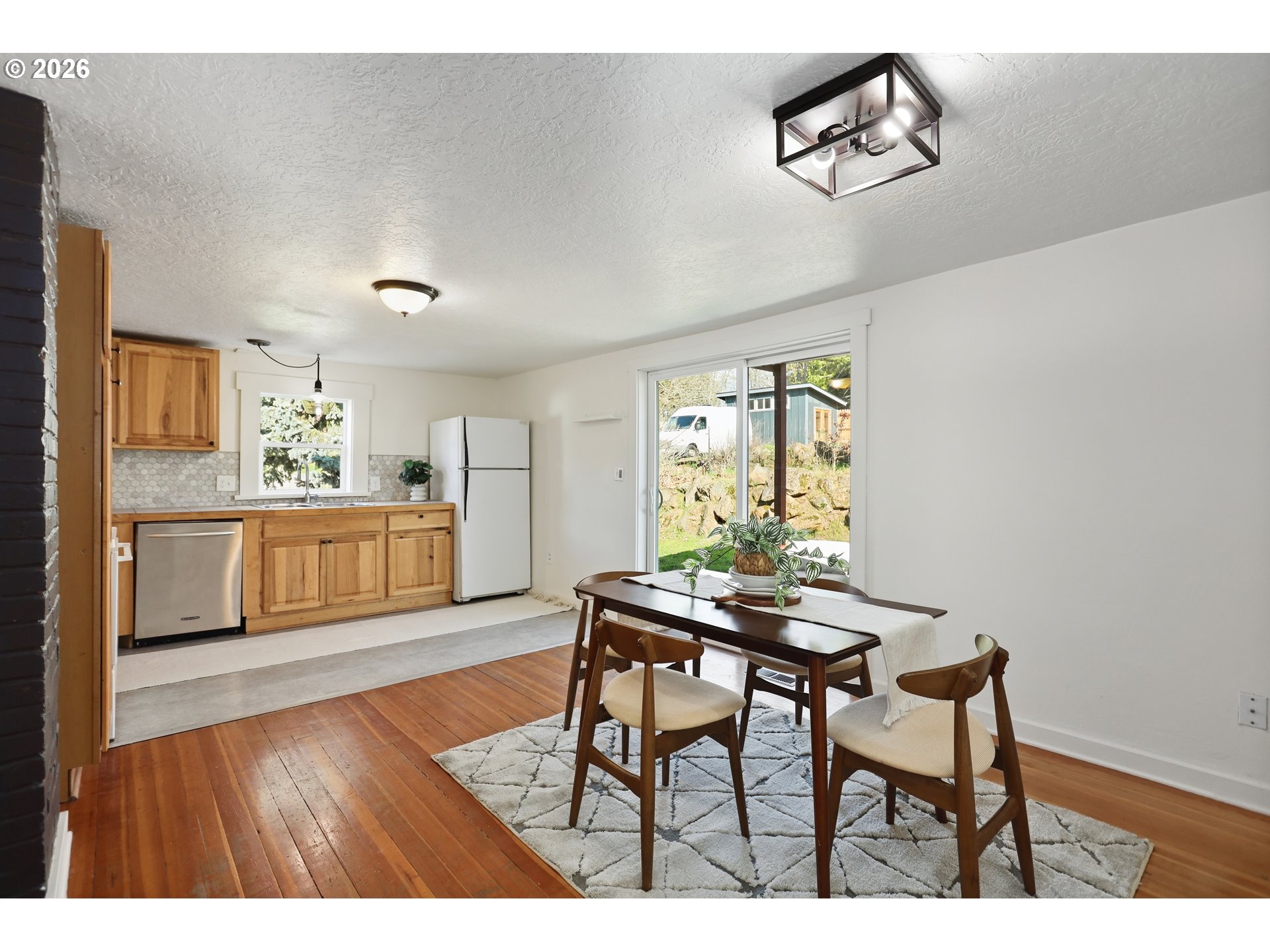 180 Northwest Spring Street White Salmon, WA 98672 - Photo 12 of 44 a living room with kitchen island furniture and a wooden floor