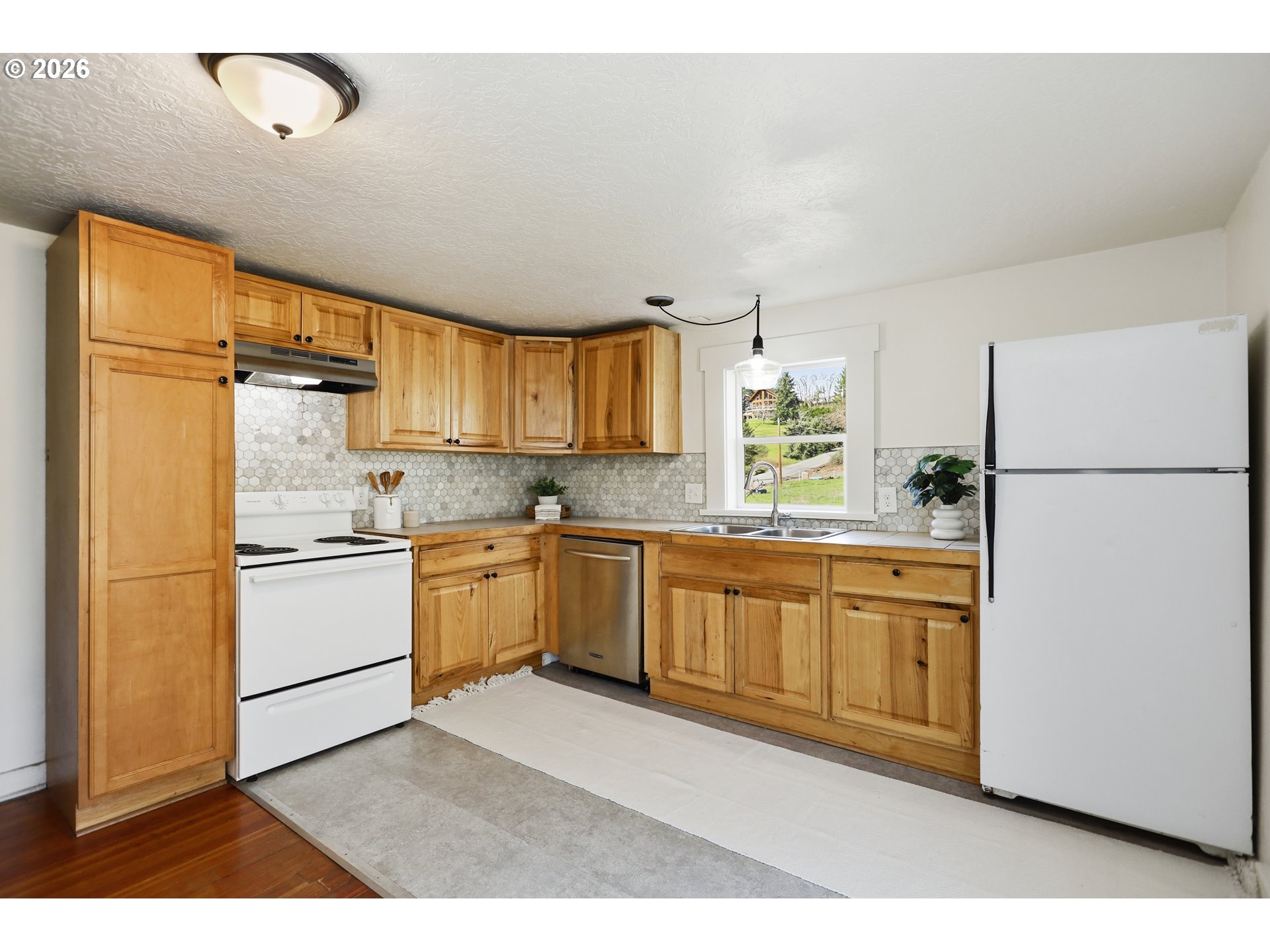 180 Northwest Spring Street White Salmon, WA 98672 - Photo 13 of 44 a kitchen with stainless steel appliances granite countertop a refrigerator sink and cabinets