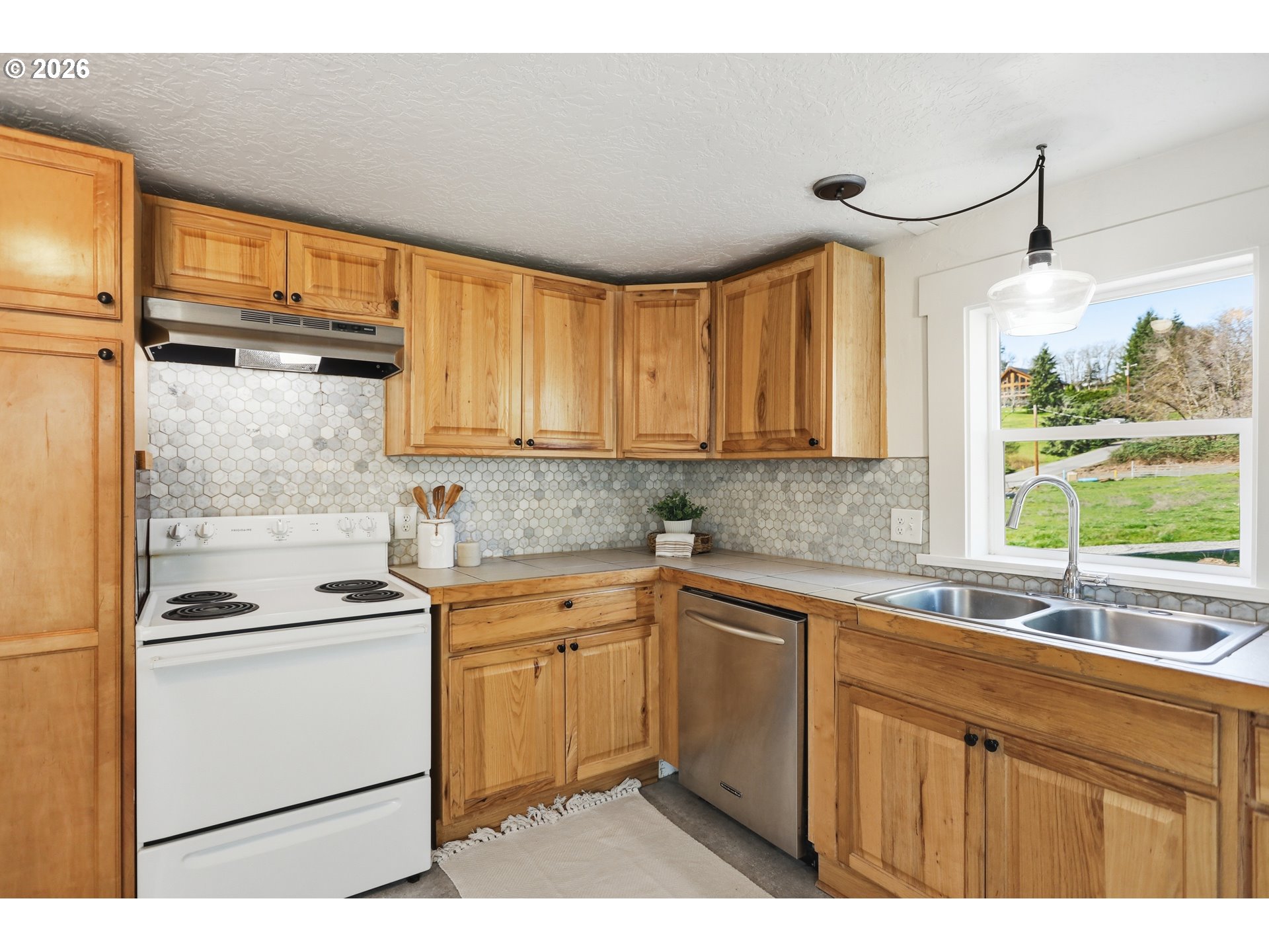 180 Northwest Spring Street White Salmon, WA 98672 - Photo 14 of 44 a kitchen with a sink stove and cabinets
