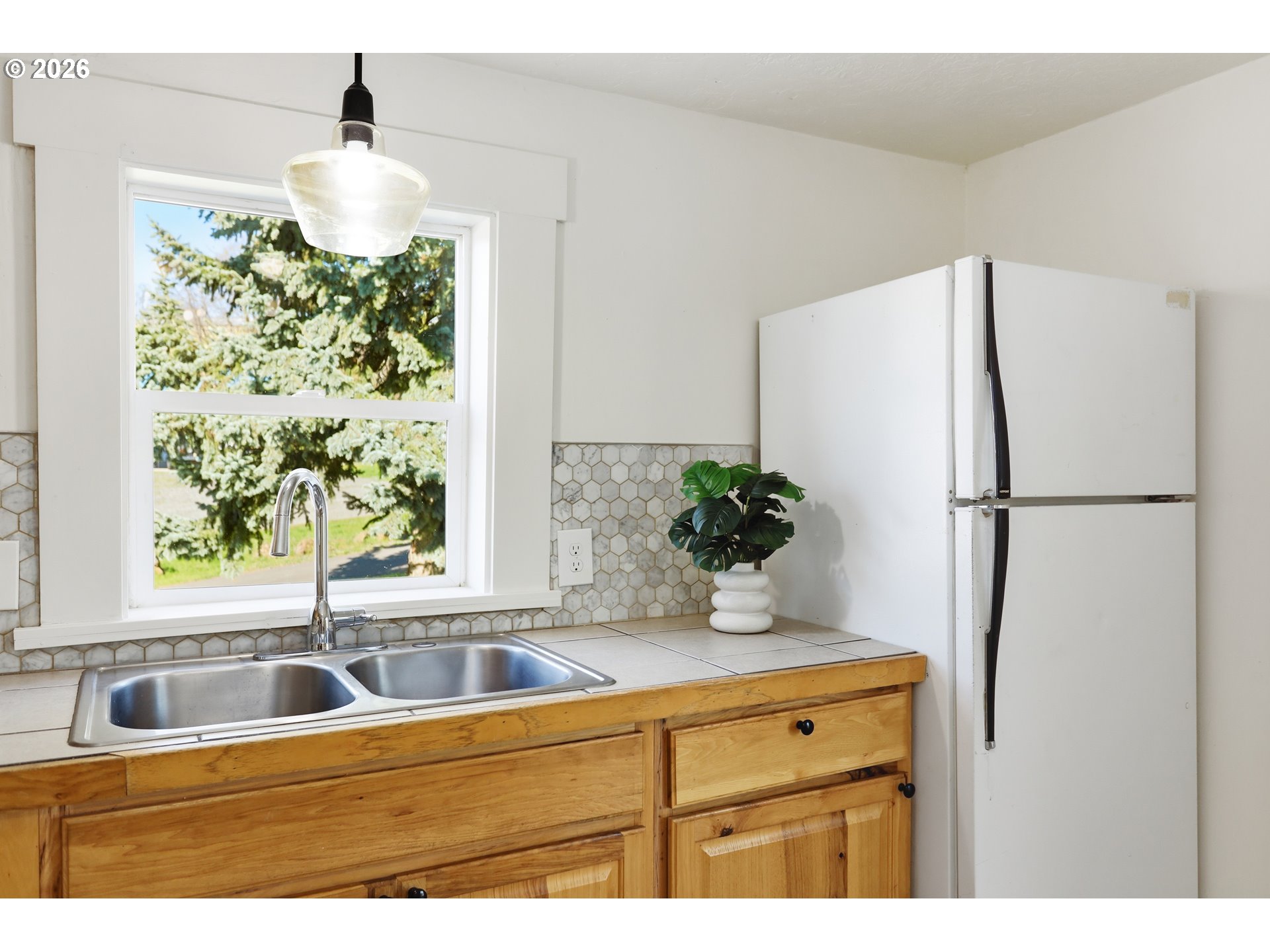 180 Northwest Spring Street White Salmon, WA 98672 - Photo 16 of 44 a kitchen with stainless steel appliances granite countertop a refrigerator a sink and a window