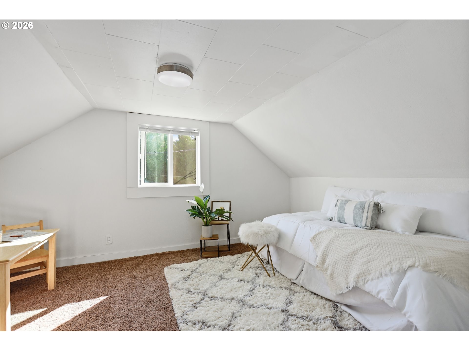 180 Northwest Spring Street White Salmon, WA 98672 - Photo 28 of 44 a bedroom with a bed and a table