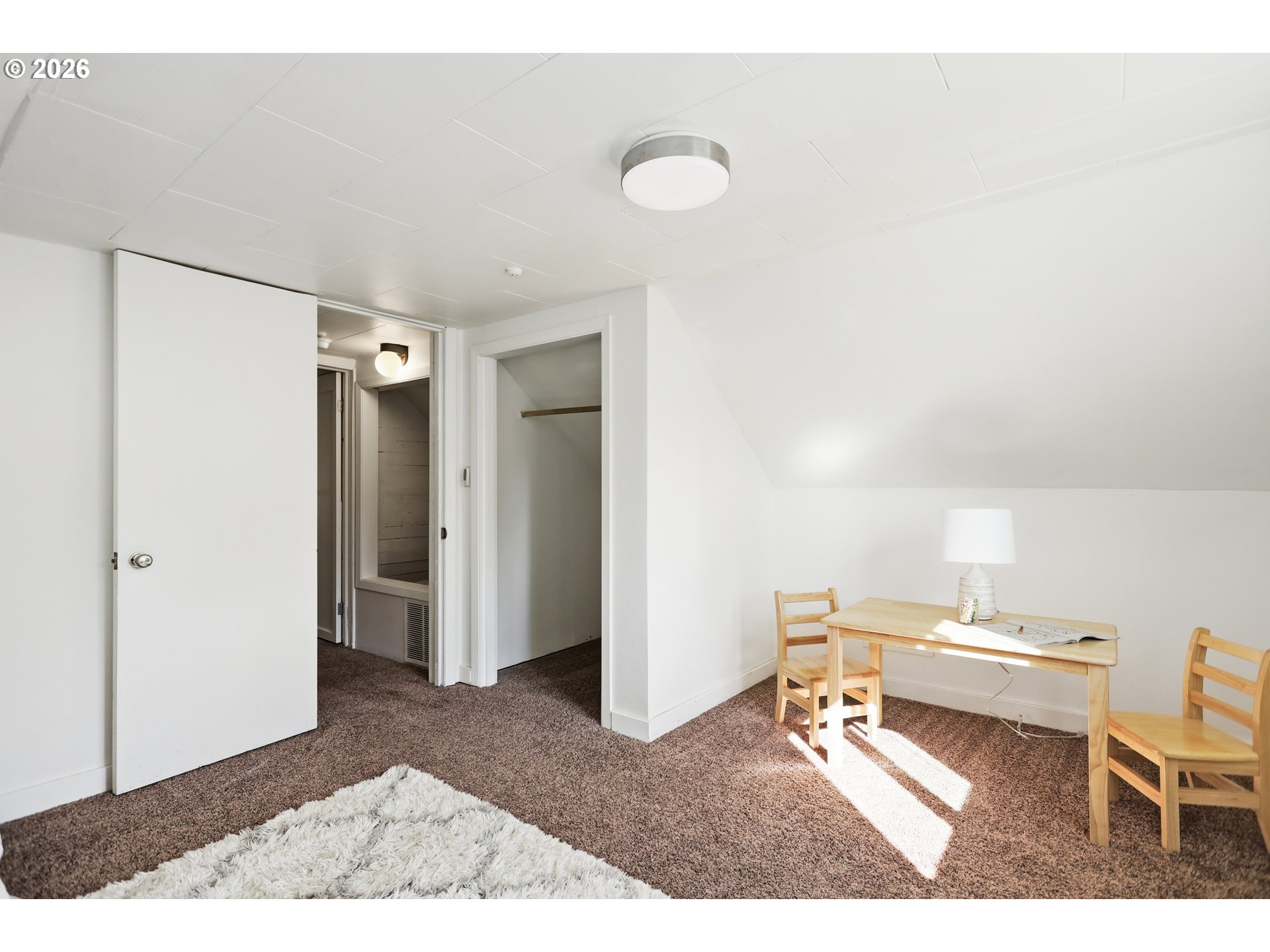 180 Northwest Spring Street White Salmon, WA 98672 - Photo 30 of 44 a living room with a table and a rug