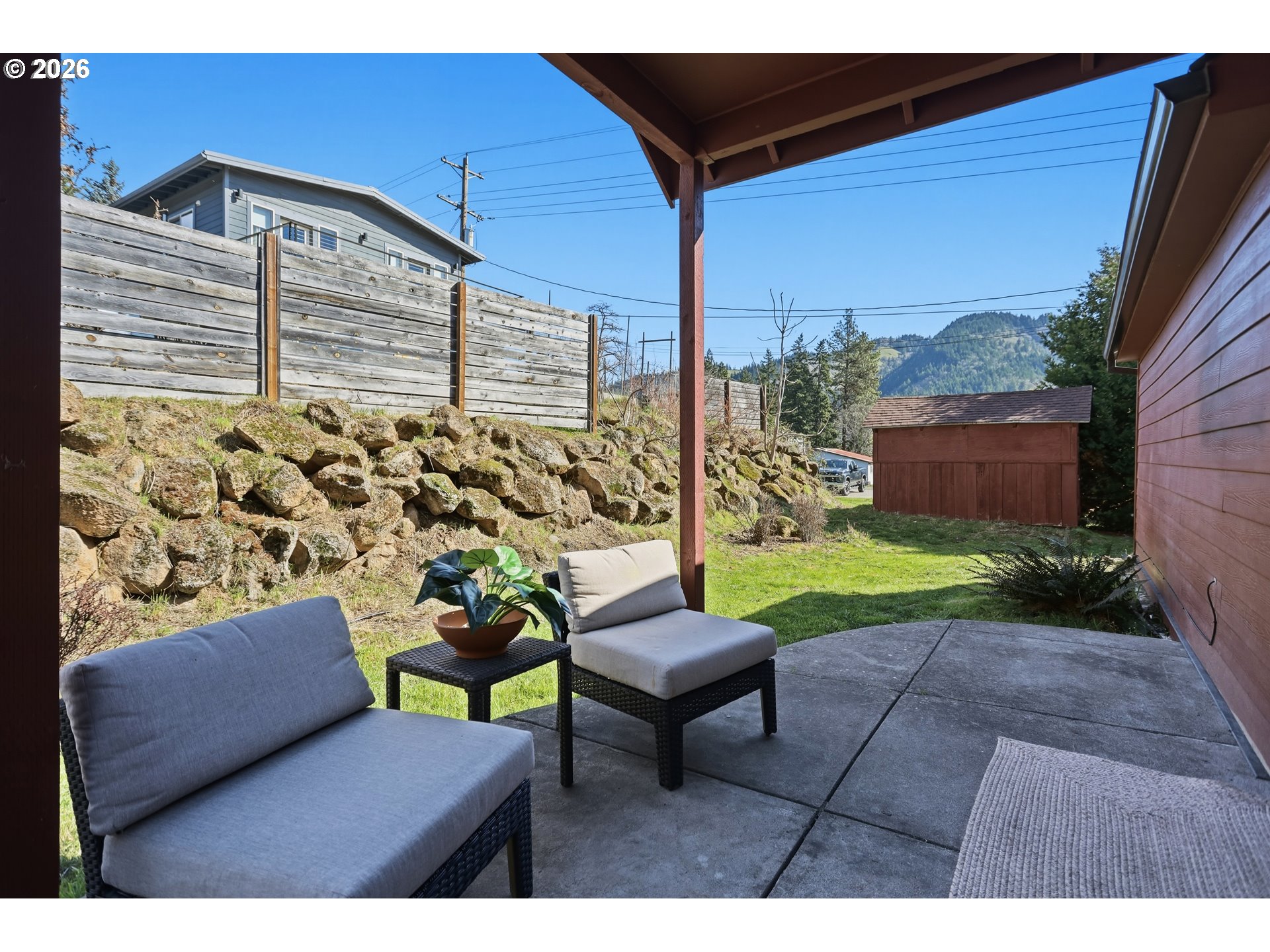 180 Northwest Spring Street White Salmon, WA 98672 - Photo 34 of 44 a view of a chairs and table in the back yard of the house