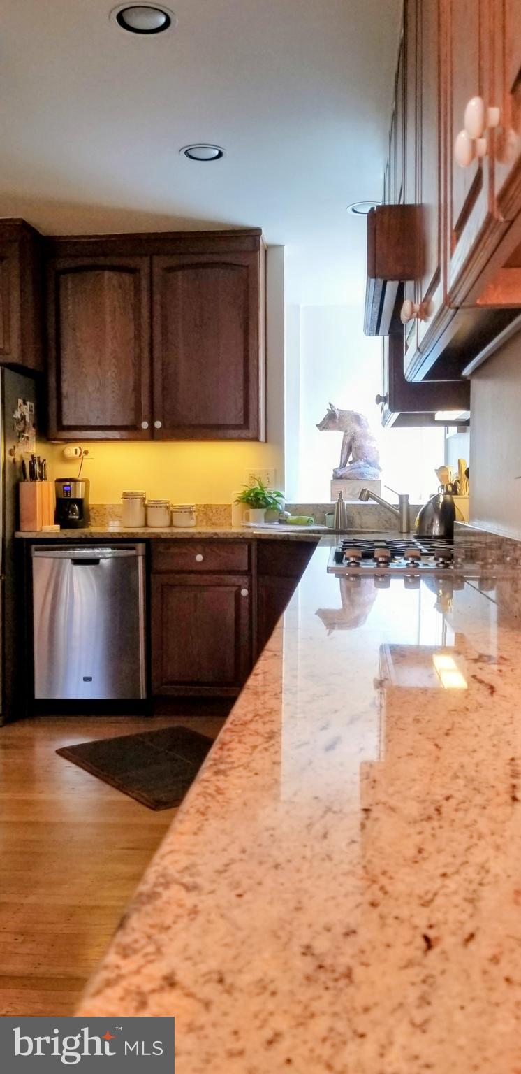 430 South 5th Street Philadelphia, PA 19147 - Photo 25 of 32 a kitchen with stainless steel appliances granite countertop a sink and a stove