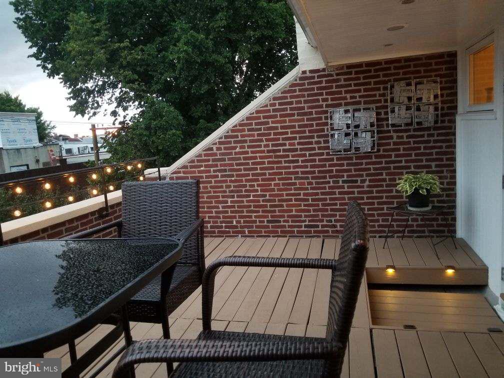430 South 5th Street Philadelphia, PA 19147 - Photo 3 of 32 a balcony with wooden floor and potted plants