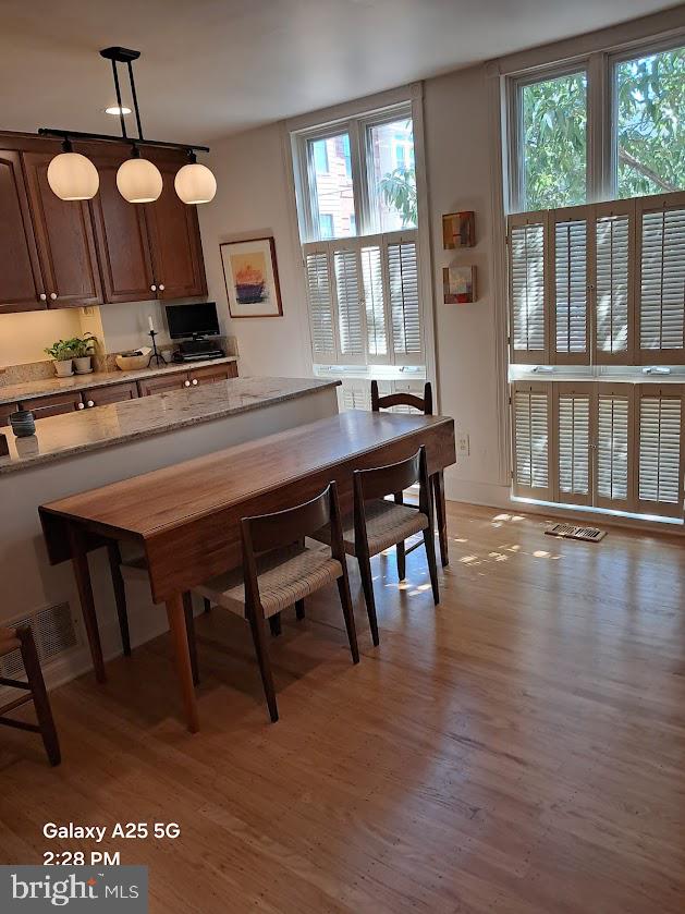 430 South 5th Street Philadelphia, PA 19147 - Photo 10 of 32 a kitchen with a table chairs stove and cabinets