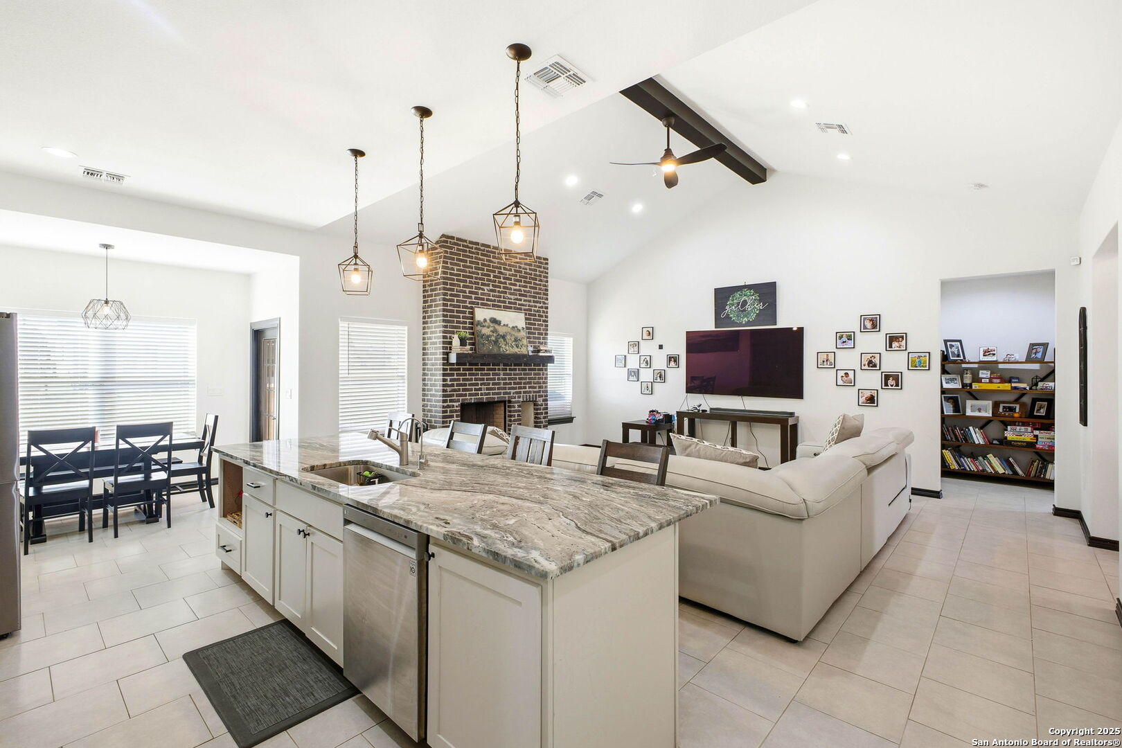 418 Tawny Oak Circle Bandera, TX 78003 - Photo 12 of 33 a living room with furniture a flat screen tv and a large window