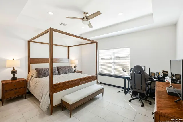 a bedroom with a bed and glass windows