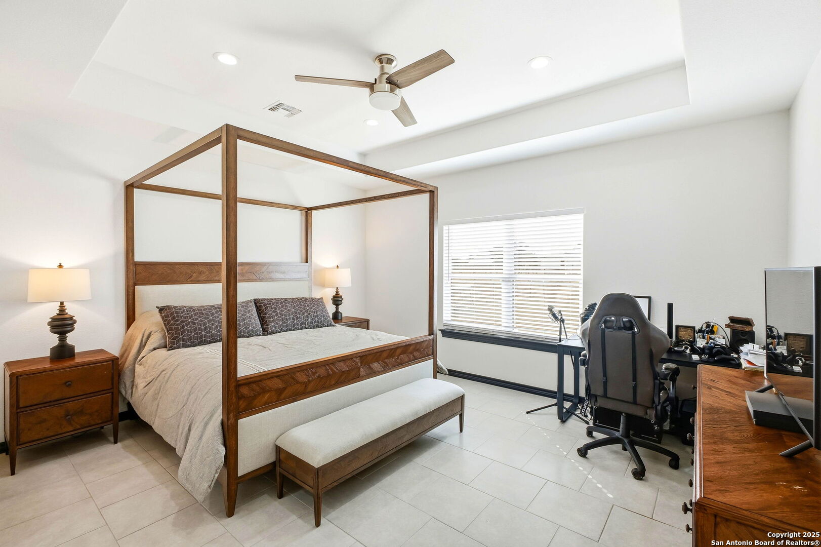 418 Tawny Oak Circle Bandera, TX 78003 - Photo 14 of 33 a bedroom with a bed a chair and a large window