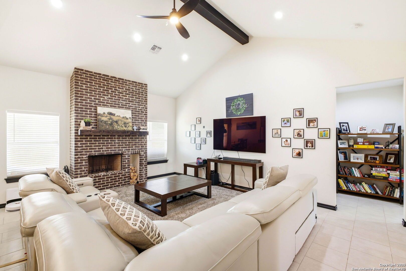 418 Tawny Oak Circle Bandera, TX 78003 - Photo 7 of 33 a living room with furniture a flat screen tv and a fireplace