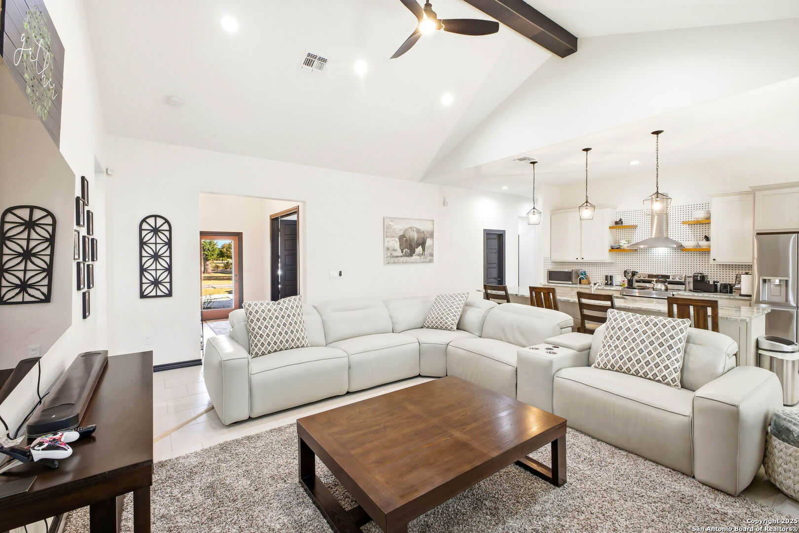418 Tawny Oak Circle Bandera, TX 78003 - Photo 8 of 33 a living room with furniture kitchen view and a chandelier