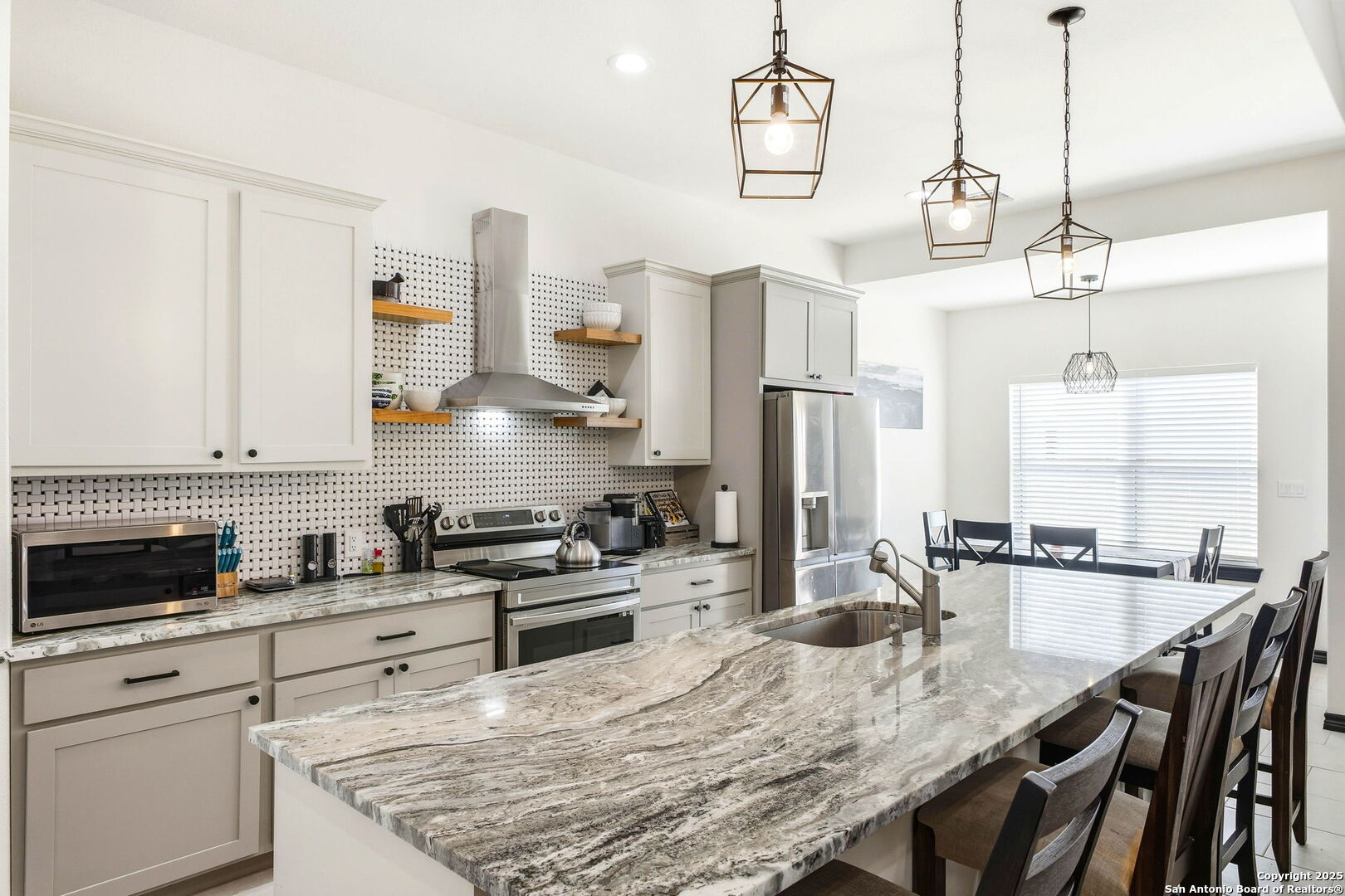 418 Tawny Oak Circle Bandera, TX 78003 - Photo 10 of 33 a kitchen with stainless steel appliances granite countertop a stove a sink a refrigerator and wooden cabinets