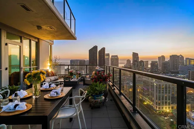 a view of a balcony with chairs and wooden floor