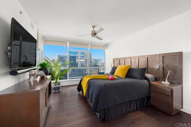 a bedroom with a bed and a flat screen tv