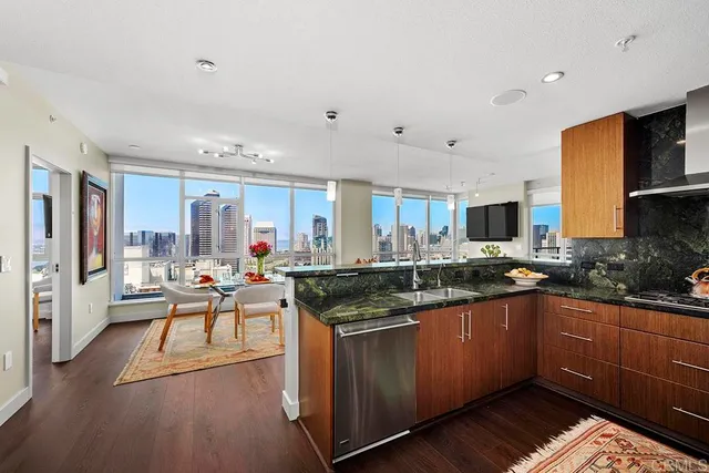 a kitchen with granite countertop a sink and cabinets