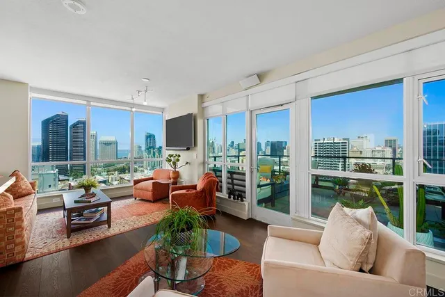 a living room with furniture fireplace and a large window