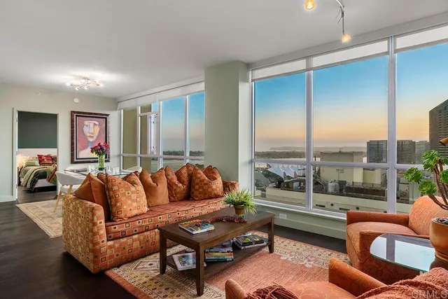 a living room with furniture city view and a large window