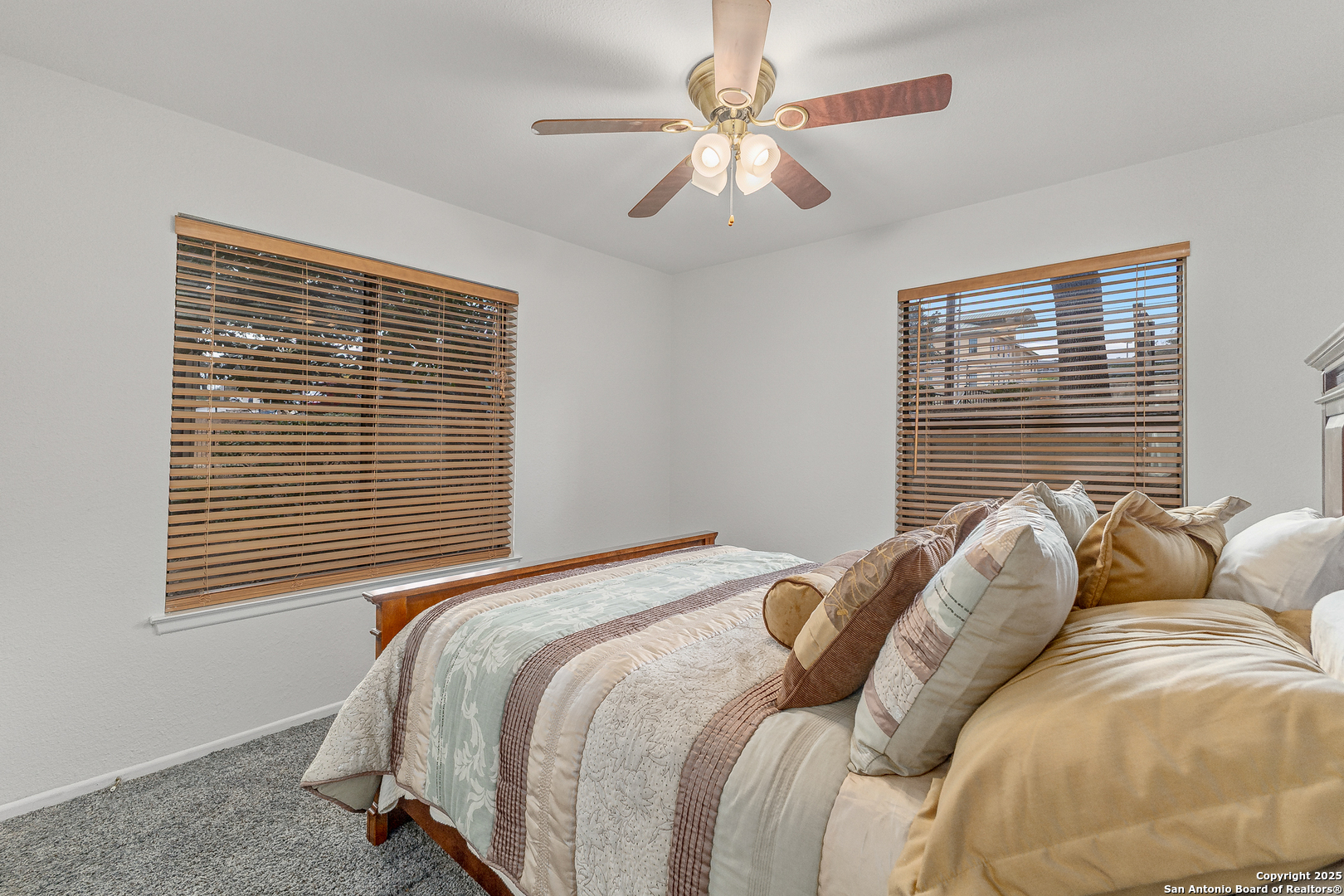 11520 Huebner Road, Unit 201 San Antonio, TX 78230 - Photo 11 of 19 a bedroom with a bed next to a window and a chandelier