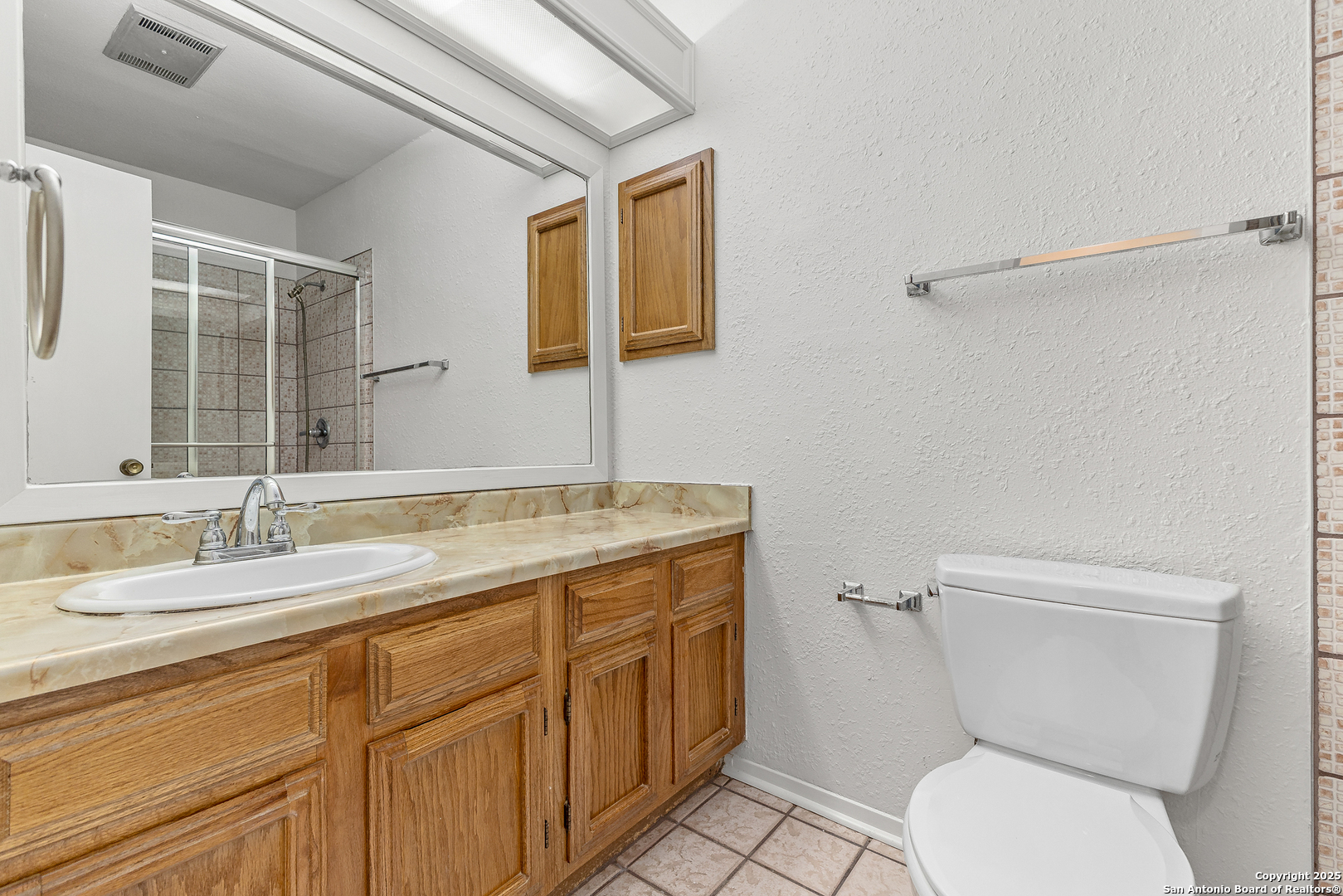 11520 Huebner Road, Unit 201 San Antonio, TX 78230 - Photo 12 of 19 a bathroom with a granite countertop toilet sink and mirror