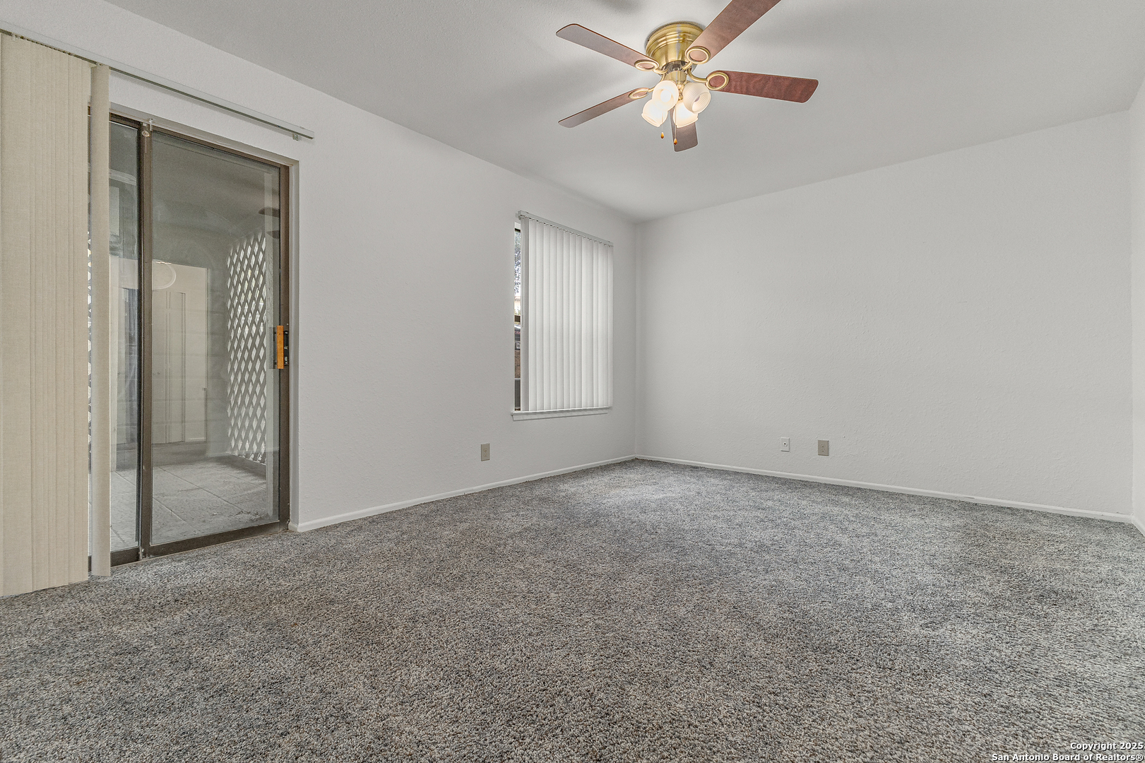 11520 Huebner Road, Unit 201 San Antonio, TX 78230 - Photo 14 of 19 an empty room with windows and fan