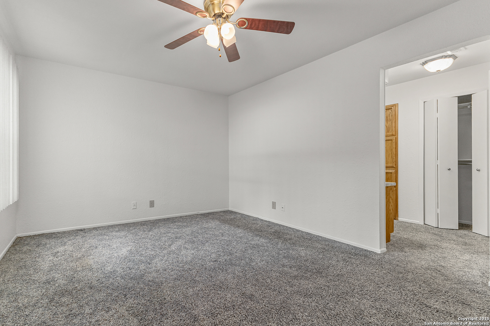 11520 Huebner Road, Unit 201 San Antonio, TX 78230 - Photo 15 of 19 an empty room with a chandelier fan and windows
