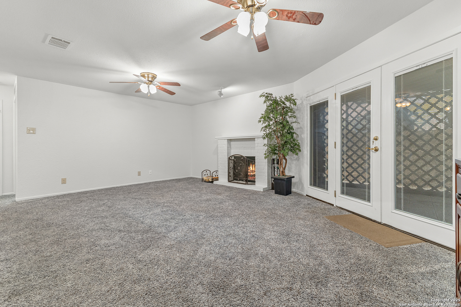 11520 Huebner Road, Unit 201 San Antonio, TX 78230 - Photo 5 of 19 a view of a livingroom with a ceiling fan and window