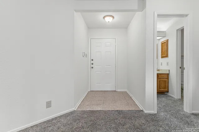 a kitchen with granite countertop a refrigerator stove top oven and sink