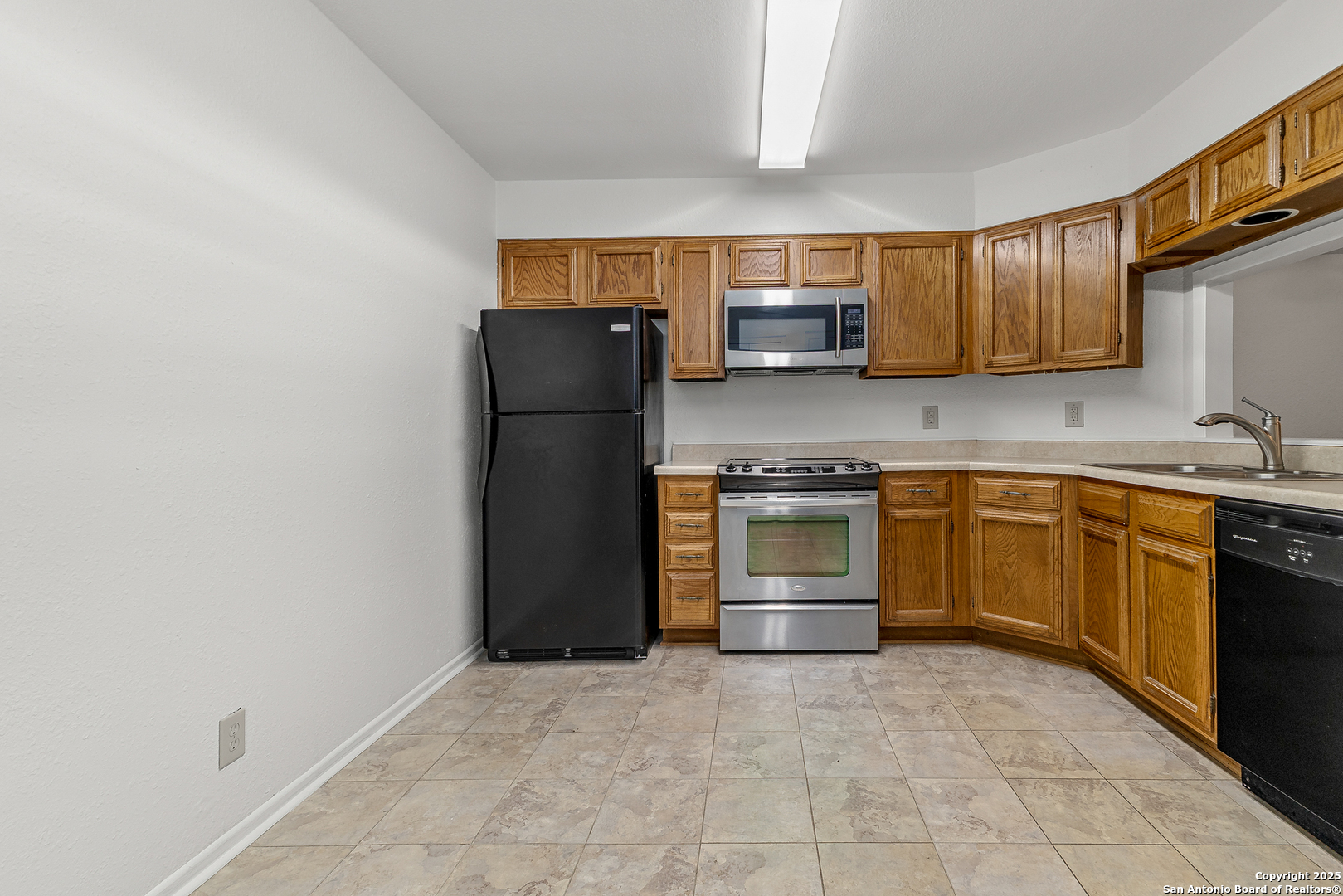 11520 Huebner Road, Unit 201 San Antonio, TX 78230 - Photo 7 of 19 a kitchen with granite countertop a refrigerator stove top oven and sink