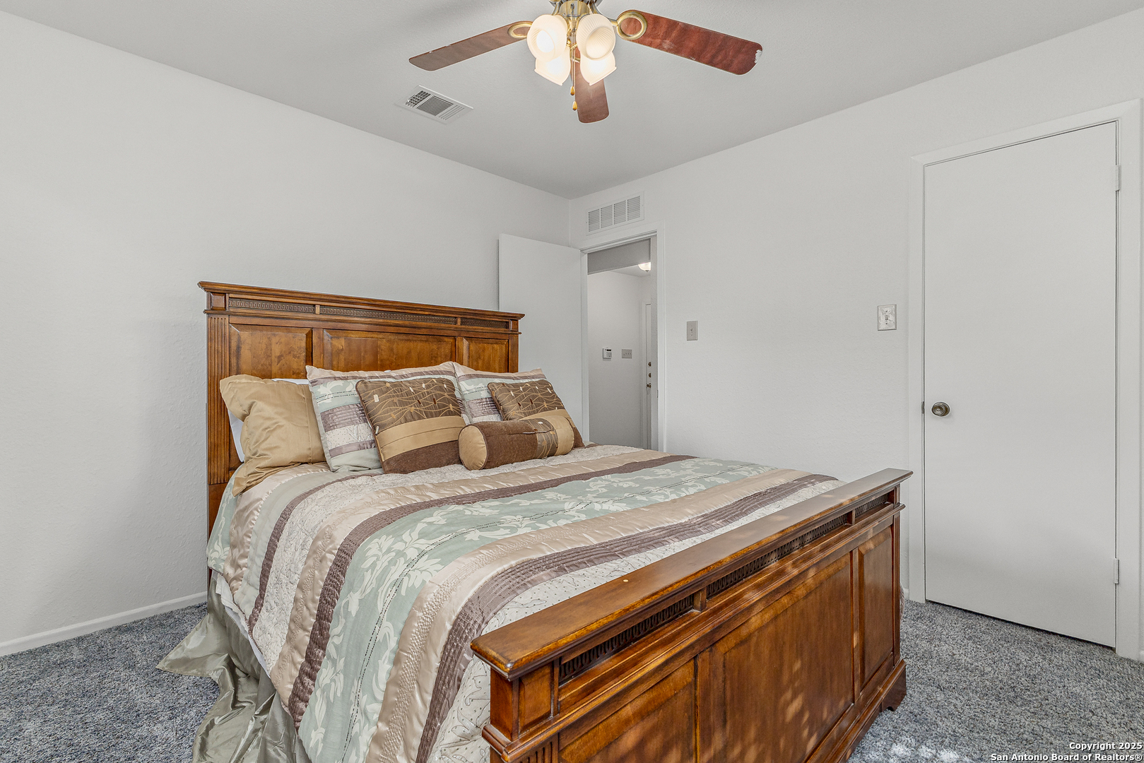 11520 Huebner Road, Unit 201 San Antonio, TX 78230 - Photo 10 of 19 a bed sitting in a bedroom and chandelier