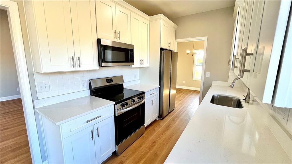 23 S Road Griffin, GA 30224 - Photo 9 of 32 a kitchen with stainless steel appliances a stove a microwave and a refrigerator