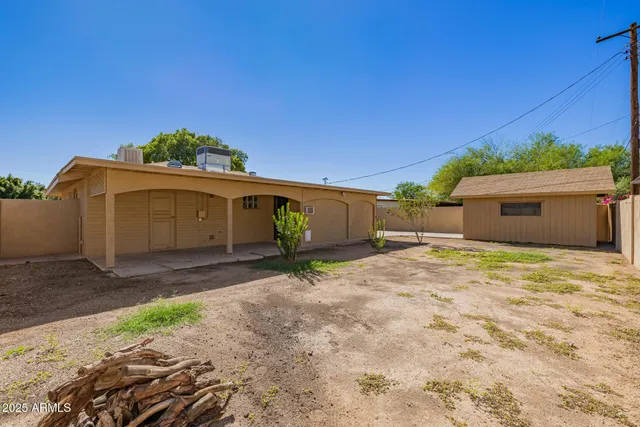 a view of a house with a yard and a garage