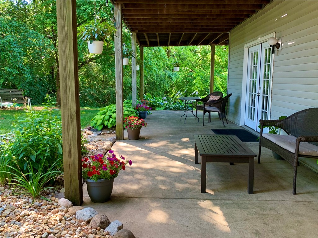 4095 West Rock Springs Road Decatur, IL 62522 - Photo 43 of 48 a view of a porch with furniture and potted plants